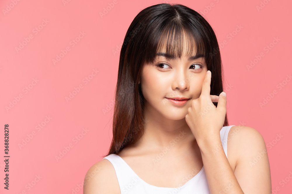 Young Beautiful Asian woman smile touching soft cheek with clean and fresh skin Happiness and cheerful with positive emotional,isolated on pink background,Beauty Cosmetics and spa Treatment Concept Young Beautiful Asian woman smile touching soft cheek with clean and fresh skin Happiness and cheerful with positive emotional,isolated on pink background,Beauty Cosmetics and spa Treatment Concept