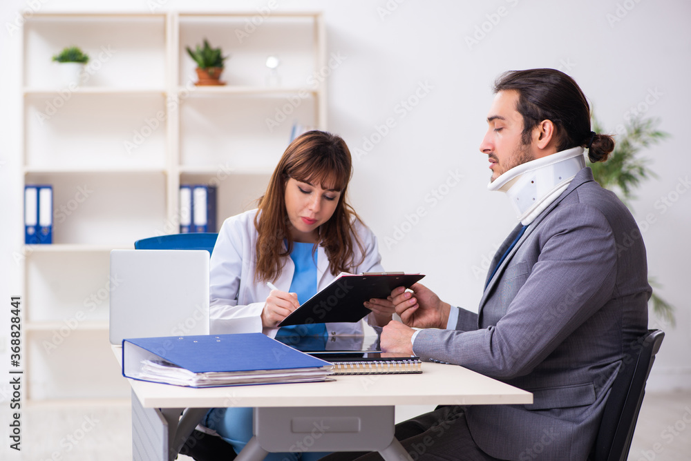 Young female doctor and sick businessman in the office Young female doctor and sick businessman in the office