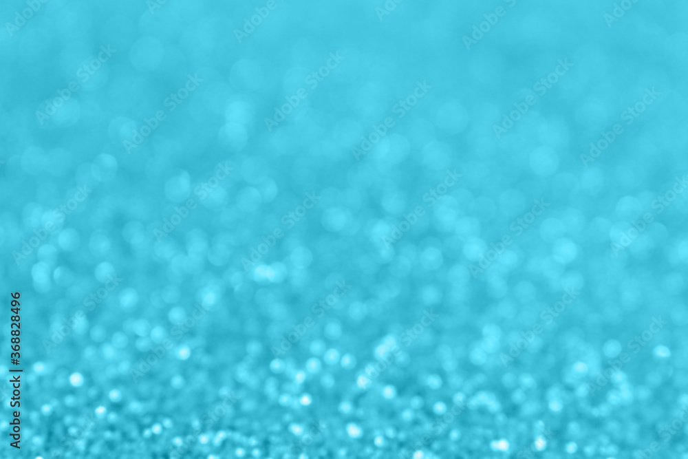 Blue glittering blur background. Festive defocused backdrop. Shiny bokeh.