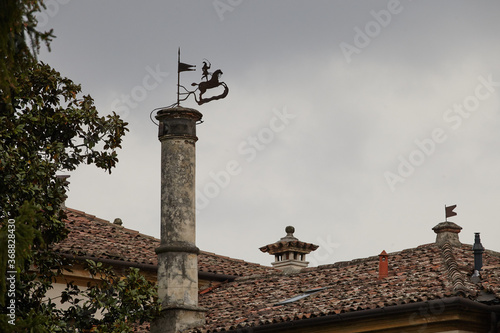 old town roofs with chimey and wind vane photo