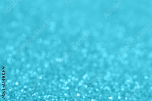 Blue glittering blur background. Festive defocused backdrop. Shiny bokeh.