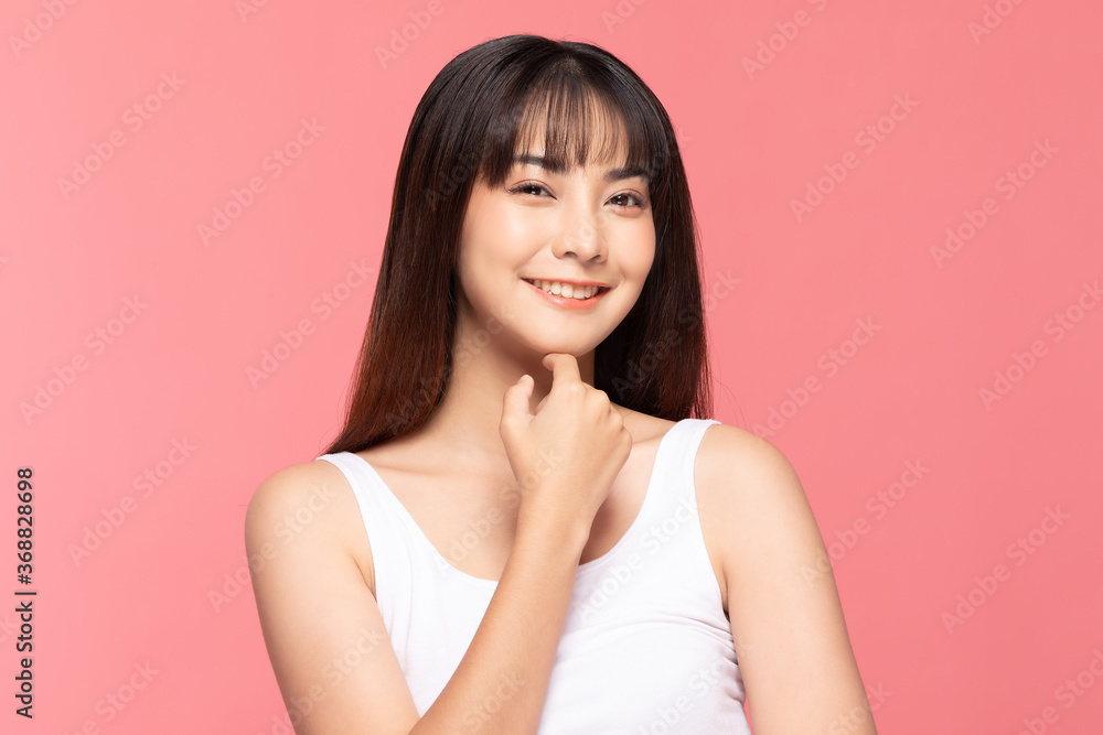 Beautiful Asian woman smile touching chin with clean and fresh skin Happiness and cheerful with positive emotional,isolated on pink background,Beauty Cosmetics and spa Treatment Concept Beautiful Asian woman smile touching chin with clean and fresh skin Happiness and cheerful with positive emotional,isolated on pink background,Beauty Cosmetics and spa Treatment Concept
