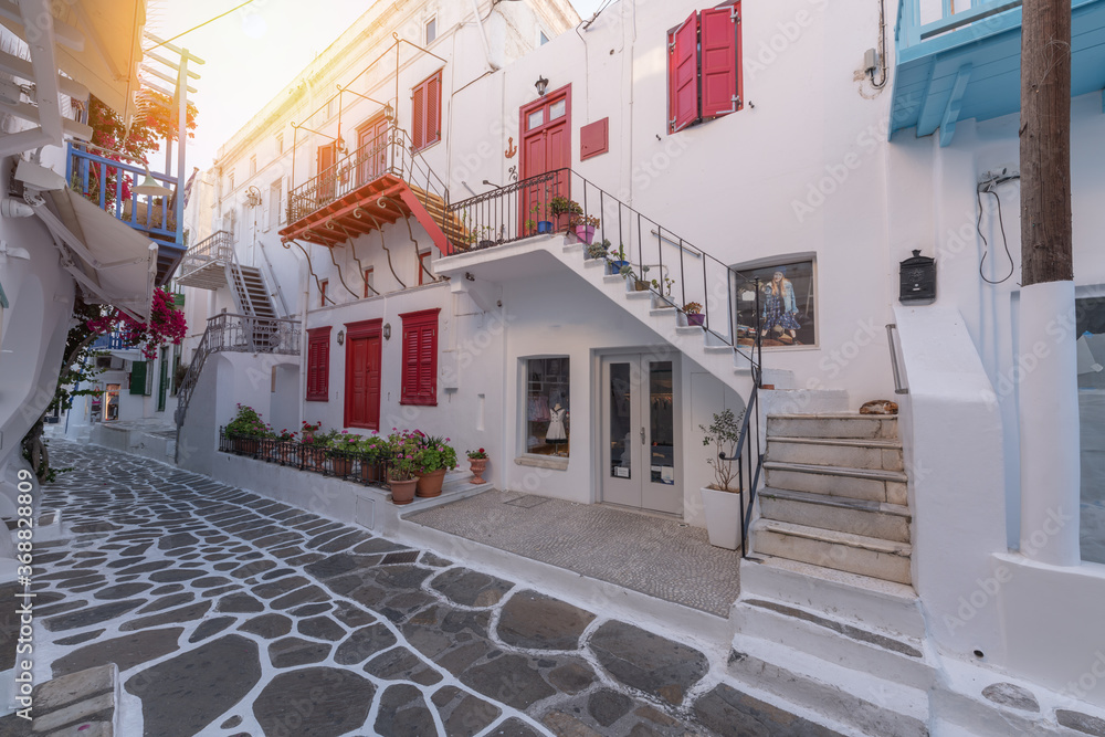 Streetview of Mykonos with whitewashed walls and doors and red windows, Greece. Travel and tourism concept.
