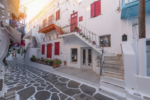 Streetview of Mykonos with whitewashed walls and doors and red windows, Greece. Travel and tourism concept.