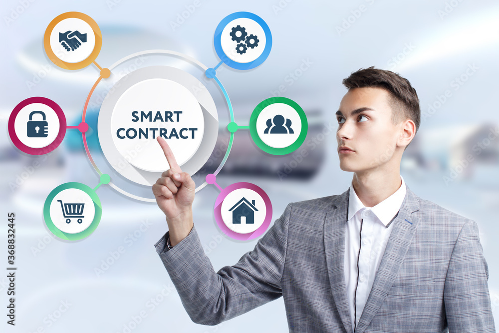 Business, Technology, Internet and network concept. Young businessman working on a virtual screen of the future and sees the inscription: Smart contract Business, Technology, Internet and network concept. Young businessman working on a virtual screen of the future and sees the inscription: Smart contract