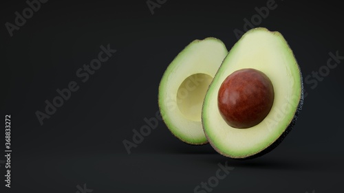 Avocado cut in half on black background.