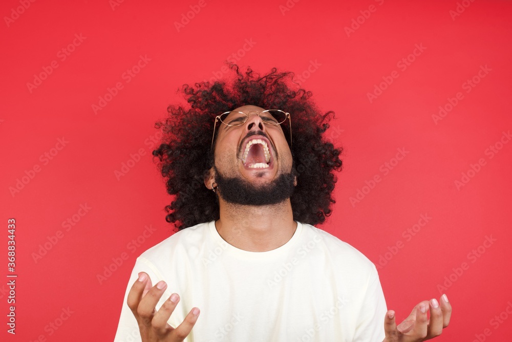 Screaming, hate, rage. Crying emotional angry man screaming on blue studio background. Emotional, young face. Female half-length portrait. Human emotions, facial expression concept. Trendy colors Screaming, hate, rage. Crying emotional angry man screaming on blue studio background. Emotional, young face. Female half-length portrait. Human emotions, facial expression concept. Trendy colors