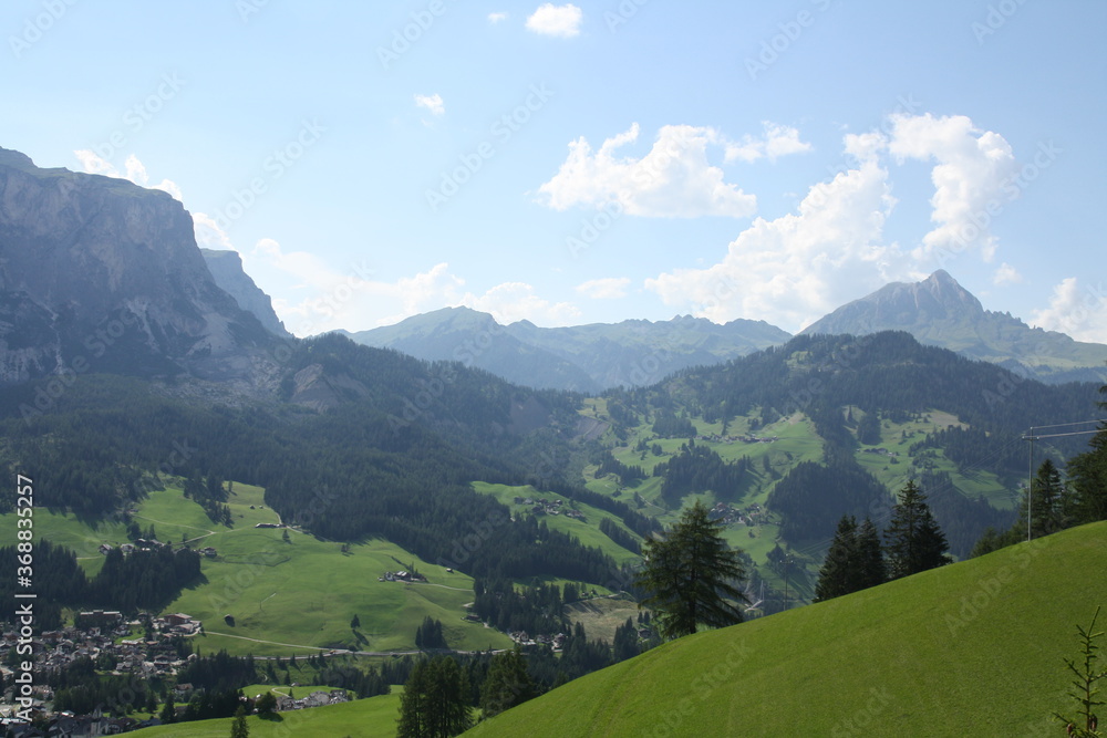 panoramic view of the meadows and mountains of the sella group in alta badia