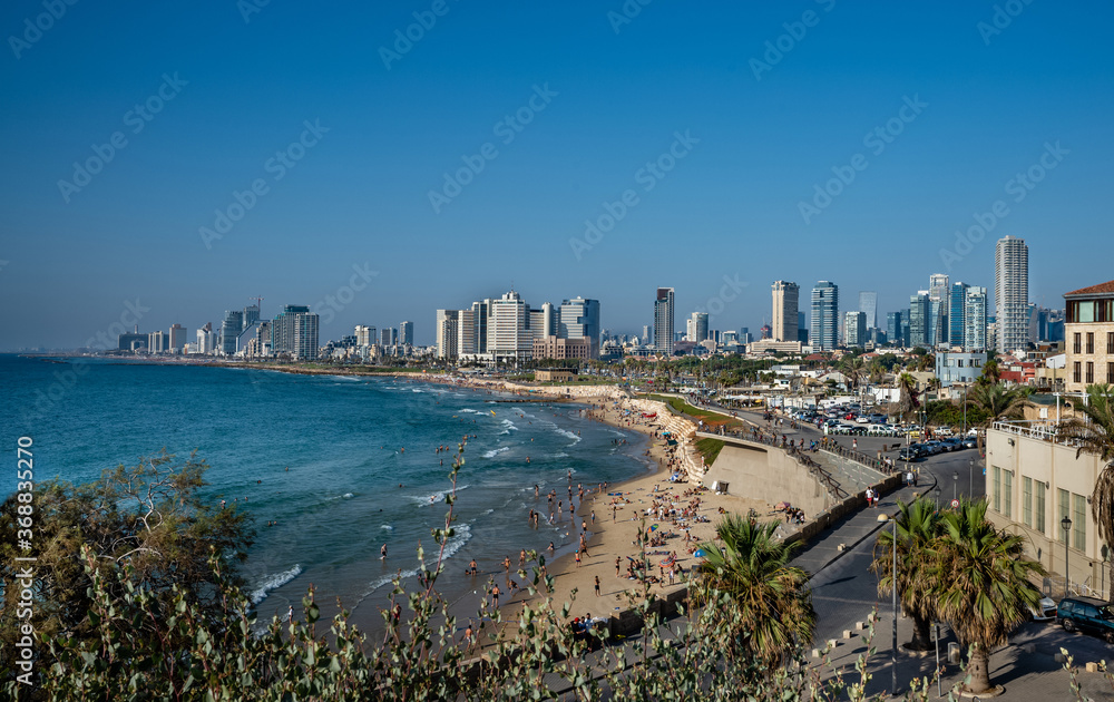 Landscape of Mediterranean sea beach and skyline of Tel Aviv.