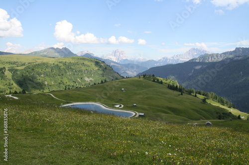 panoramic view of the meadows, lakes and mountains of the sella group in alta badia