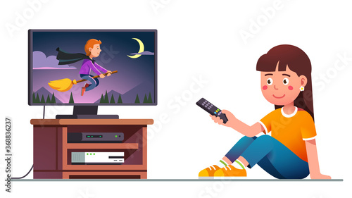 Kid watching tv with remote control in hand
