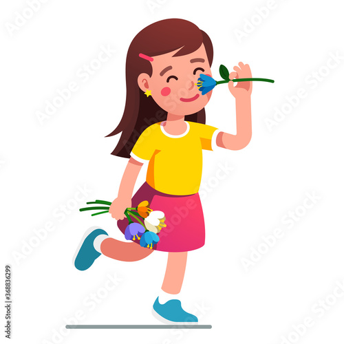 Girl smelling flower. Kid holding tulip bouquet