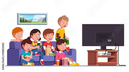 Boys, girls sitting on sofa watching movie show