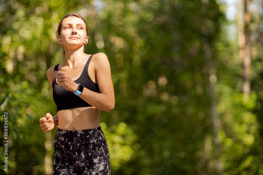 Beautiful young woman runner in a green forest. Beautiful young woman runner in a green forest.