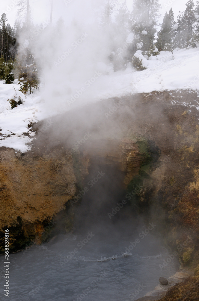 Dragons Mouth hot spring in Mud Volcano area of Yellowstone National Park in winter