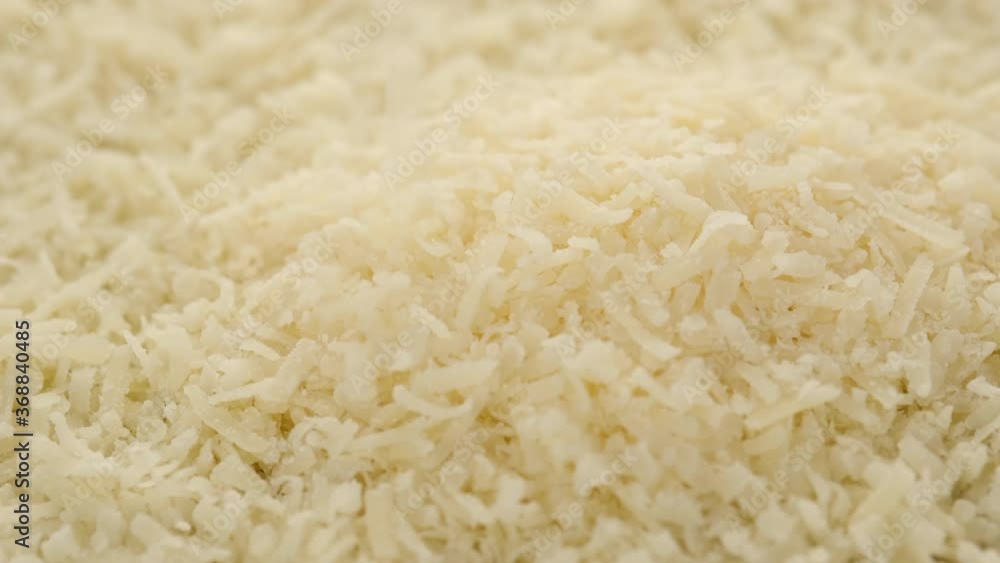 put grated cheese parmesan close up, rotating put grated cheese parmesan close up, rotating