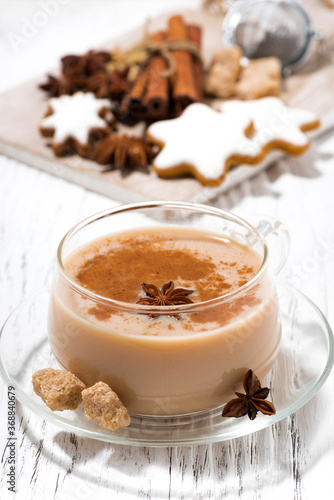 cup of masala tea and Christmas cookies on white background, closeup