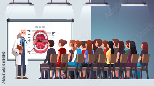 Elder dentist professor giving lecture to students