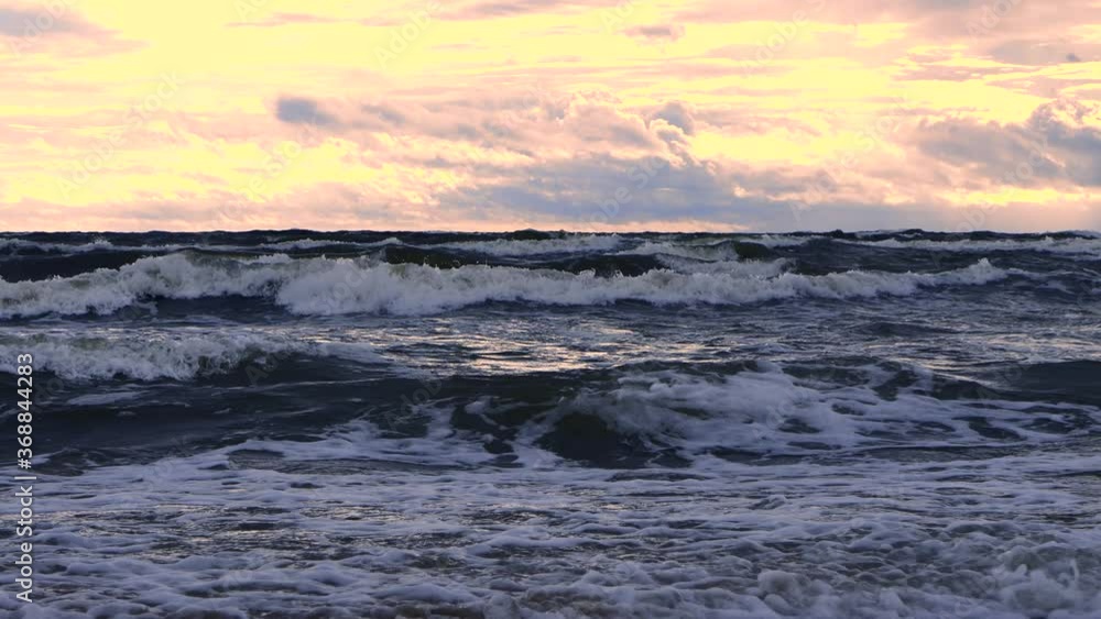 Waves at sea during a thunderstorm at sunset Waves at sea during a thunderstorm at sunset