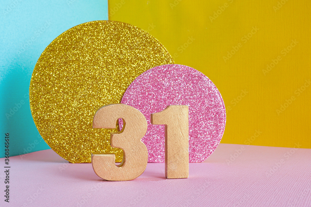 golden number "31" on a multicolored blue-yellow-pink background and
