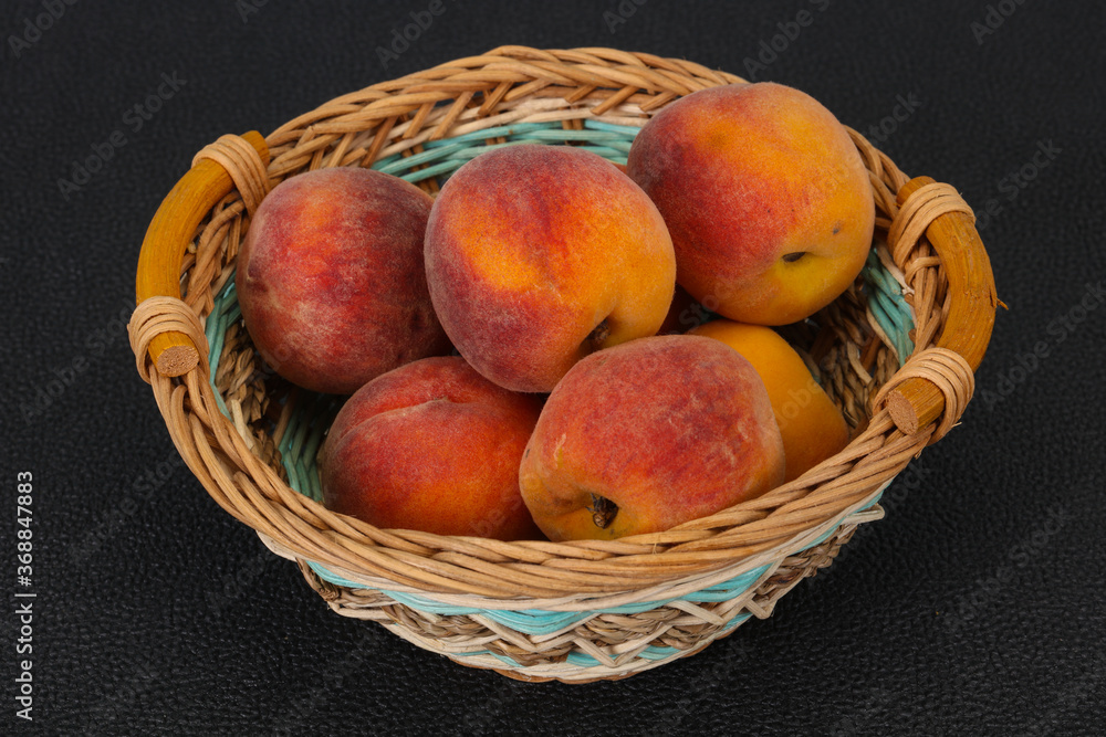 Peach heap in the wooden basket Peach heap in the wooden basket