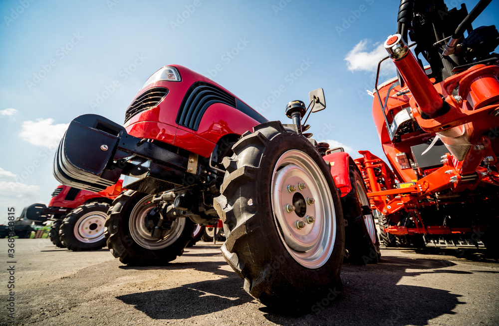 Obraz premium Rows of modern tractors. Industrial details. Agricultural 