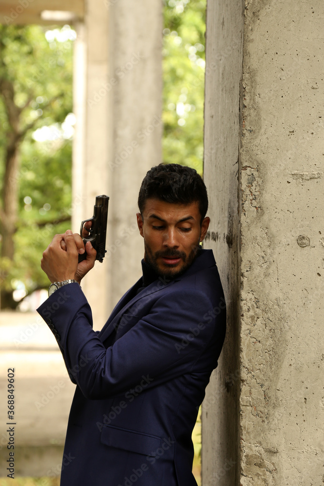 A man with a pistol in his hands A man with a pistol in his hands