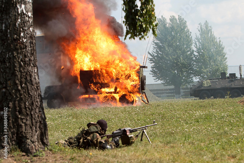 Foto Military convoy trucks are driving on the road