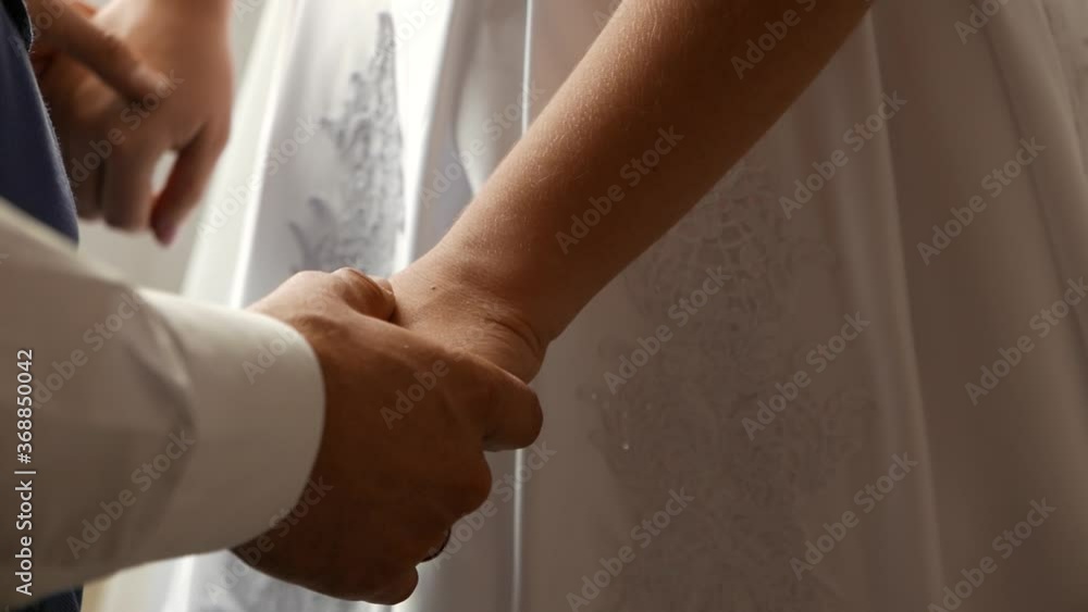 Hands of the bride and groom close up. Newlyweds hold hands. Hands of the bride and groom close up. Newlyweds hold hands.