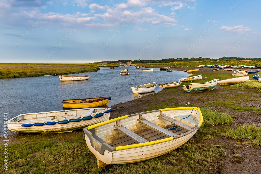 Small boats beached on the banks of the River Glaven, Norfolk