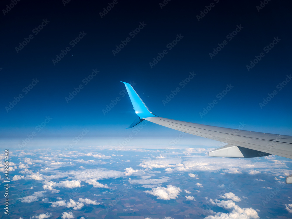 Fototapeta premium Travel by air. View from the wing of the aircraft at sunsets, sunrises, clouds.