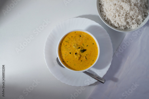 Delicious south Indian style mango curry with white rice, white background, top view
