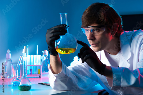 Chemist with a flask in his...