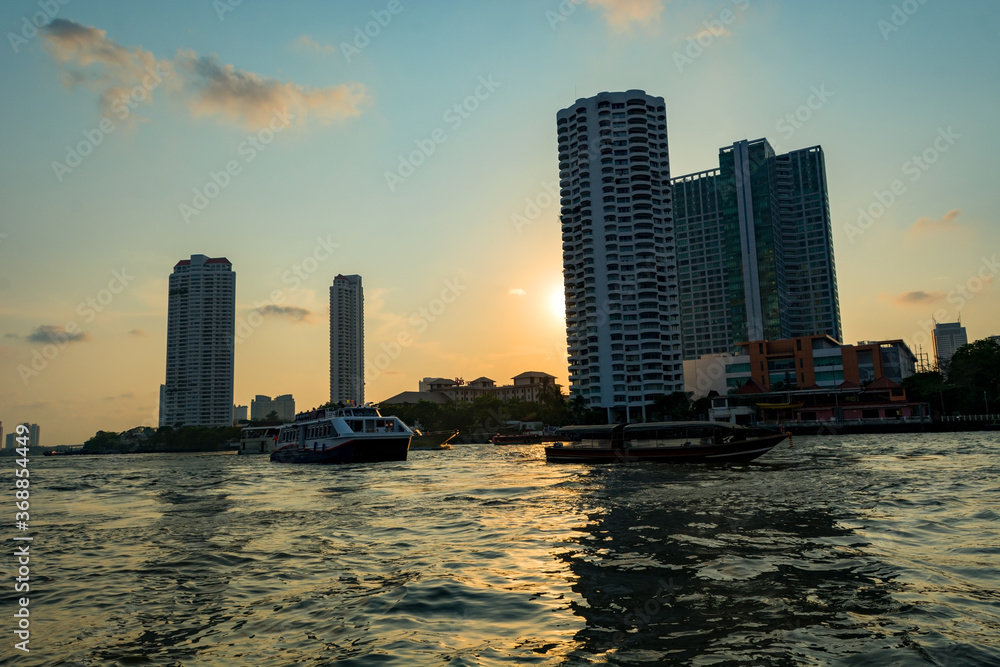 Skyline view of apartment buildings and hotels from boat on  Chao Phraya river in Bangkok, Thailand