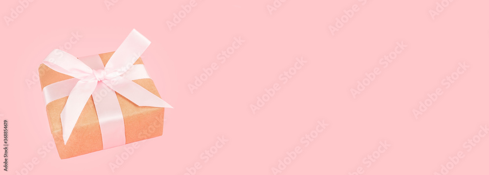 Congratulatory festive banner. Gift on a pink background with copy space. Congratulatory festive banner. Gift on a pink background with copy space.