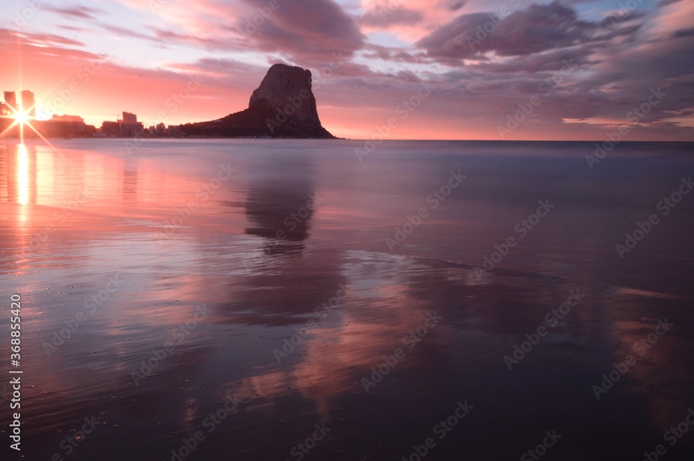 Mountain on the beach at sunrise and clouds
