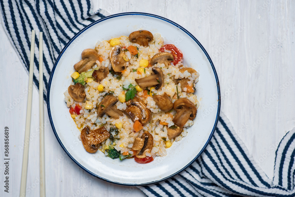 Vegetarian risotto with mushrooms and vegetables on a plate Vegetarian risotto with mushrooms and vegetables on a plate