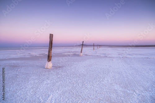 Purple sunset on a salt lake. Pink sunset on the sea.