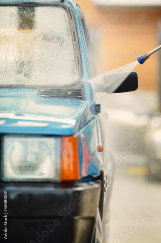 Man in car wash take care of his lovely retro car