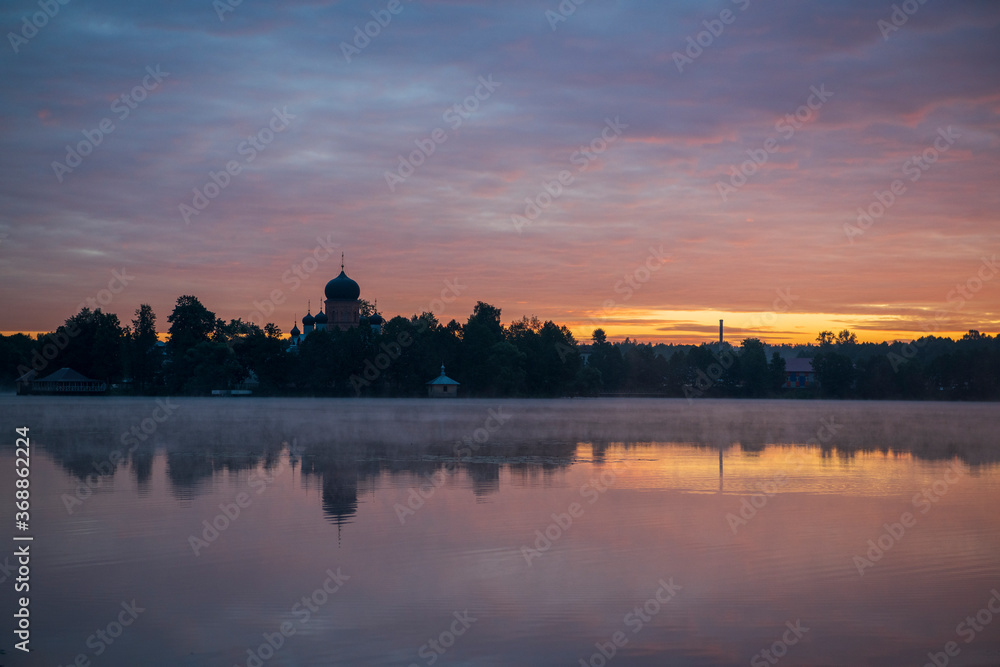 Naklejka premium island ancient monastery in the middle of the lake at sunrise