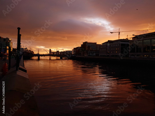 Sunrise over the River Liffey in Dublin. View from the river bank, towards the Dublin Port.