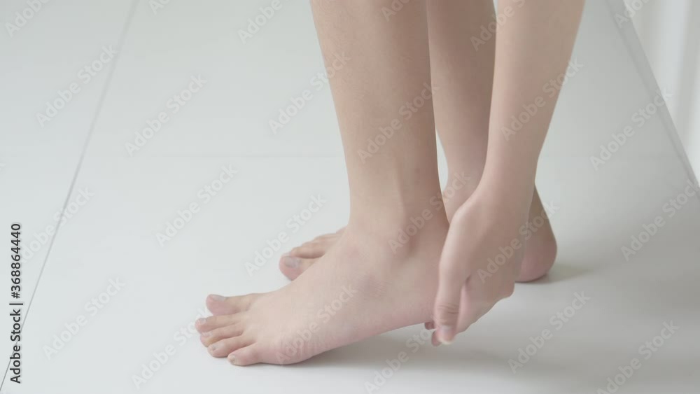 Beautiful young asian woman touch skin heel smooth with cream and lotion for hydration and smooth, girl applying body care and cosmetic with leg for silky and soft, beauty perfect with health. Beautiful young asian woman touch skin heel smooth with cream and lotion for hydration and smooth, girl applying body care and cosmetic with leg for silky and soft, beauty perfect with health.