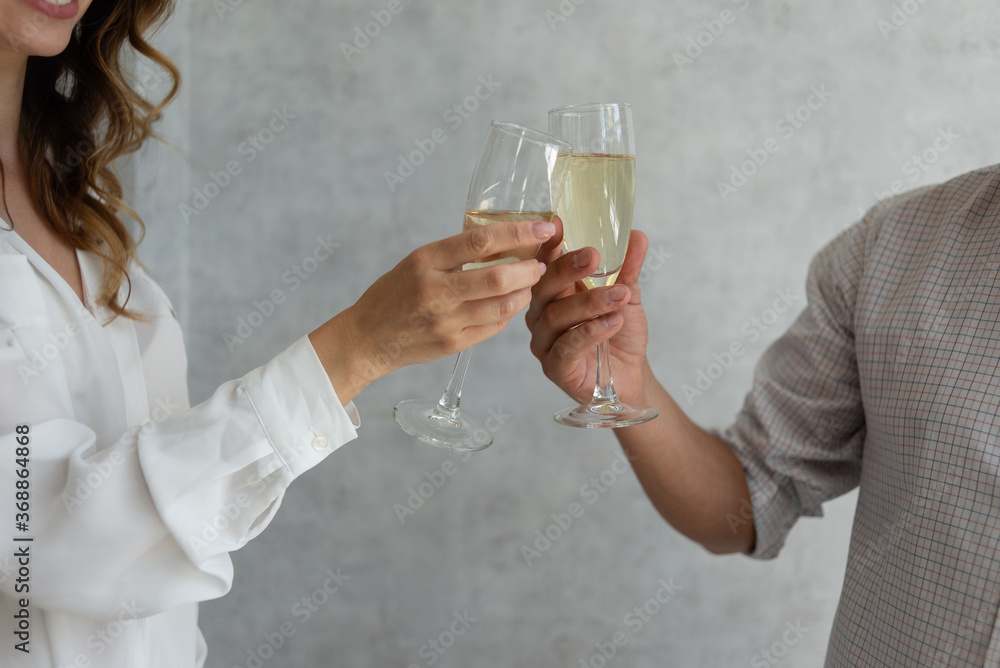 Close up of two glasses of champagne in male and female hands. Christmas concept, saint valentine. Close up of two glasses of champagne in male and female hands. Christmas concept, saint valentine.