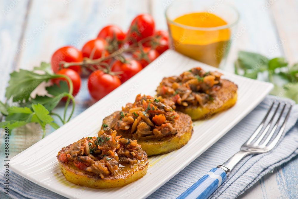 canapes with clam with tomatoes sauce and turmeric spice canapes with clam with tomatoes sauce and turmeric spice