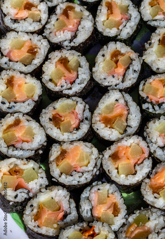 Top view of stack of Japanese sushi maki roll plate. Served in Japanese bar restaurant with chopstick Top view of stack of Japanese sushi maki roll plate. Served in Japanese bar restaurant with chopstick