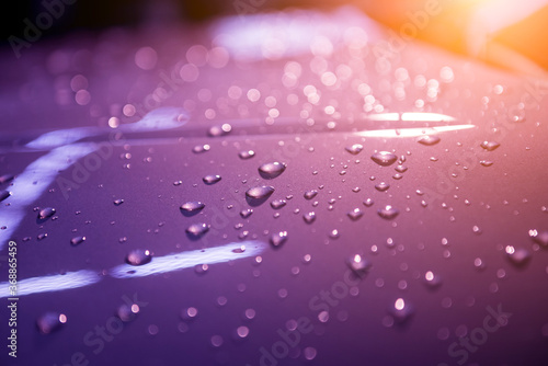Water drops on violet background. Car details