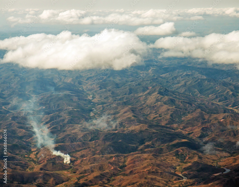 Fototapeta premium Eastern Madagascar: aerial view of burning, deforested and degraded hills 
