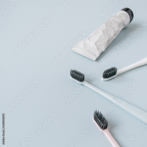 Toothbrushes  toothpaste on blue background. Flat lay  top view oral care  dental hygiene concept.