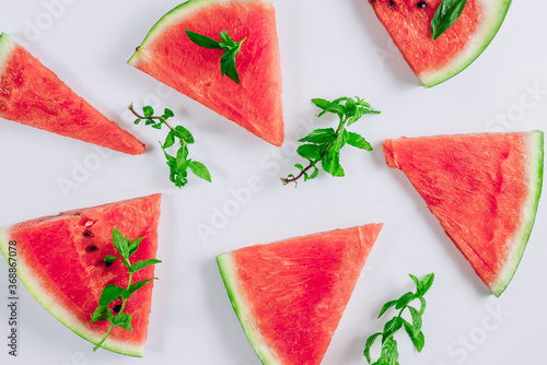 Top view of watermelon slices and mint leaves on white background