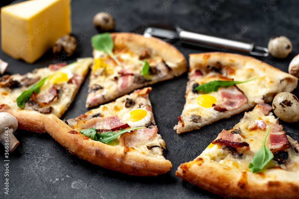 Pizza carbonara with bacon, cheese, mushrooms, quail eggs, creamy sauce on a stone background Pizza carbonara with bacon, cheese, mushrooms, quail eggs, creamy sauce on a stone background